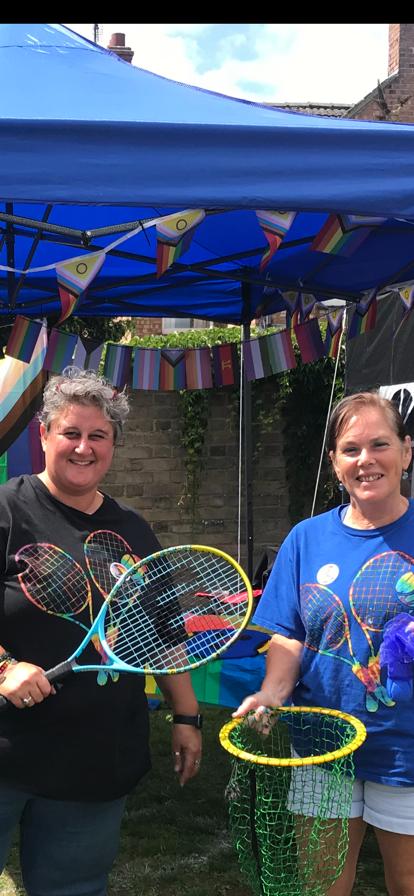 Emma and Fiona with tennis rackets at Pride
